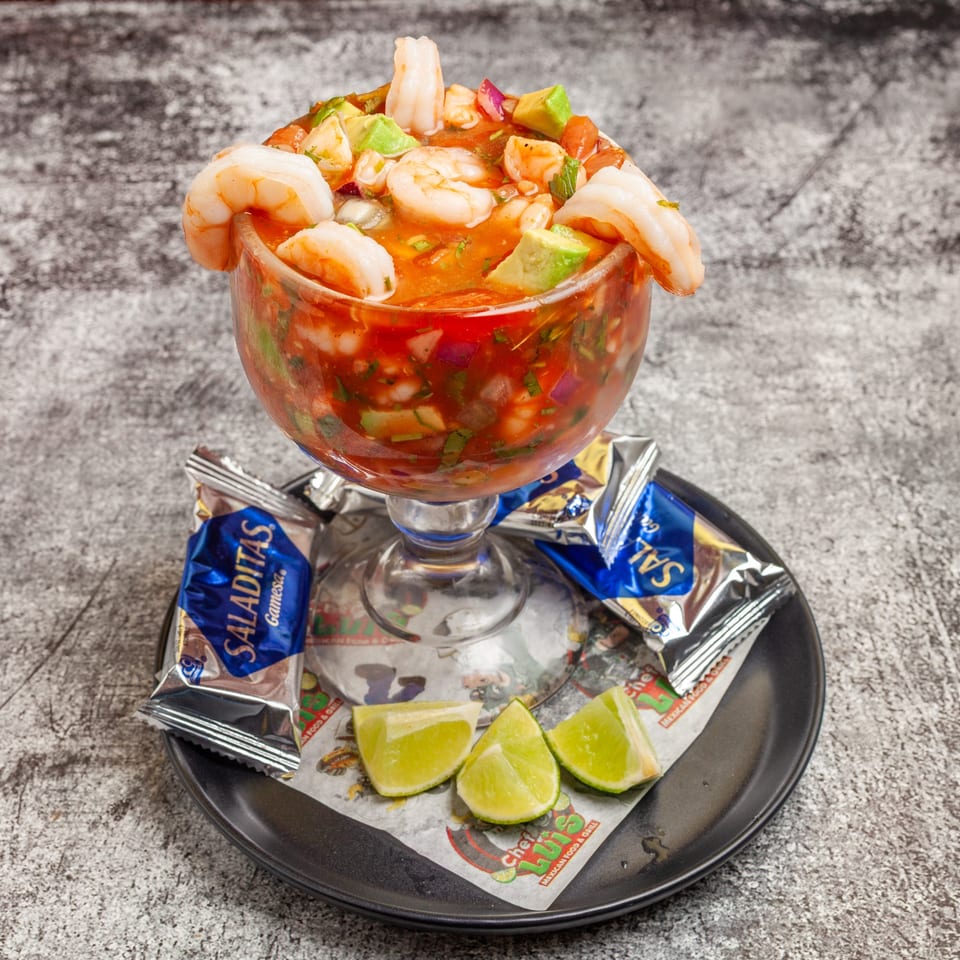 Luis Mexican Food & Grill's shrimp ceviche cocktail with avocado, lime wedges, and crackers.