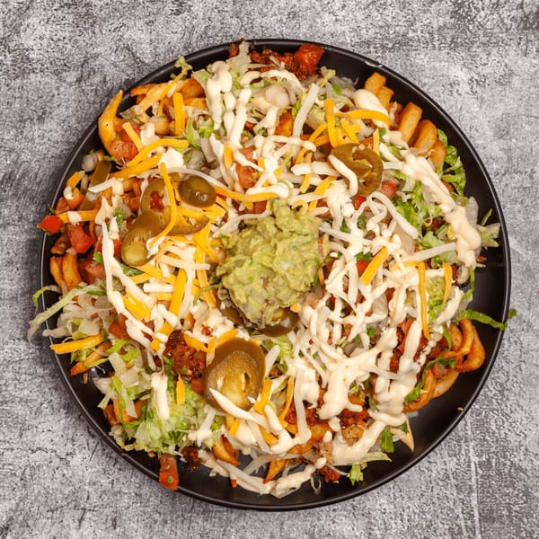 Luis Mexican Food & Grill's loaded curly fries with cheese, lettuce, jalapeños, and guacamole.