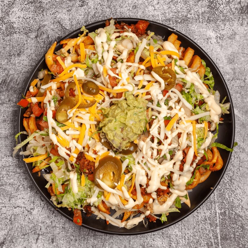 Luis Mexican Food & Grill's loaded curly fries with cheese, lettuce, jalapeños, and guacamole.